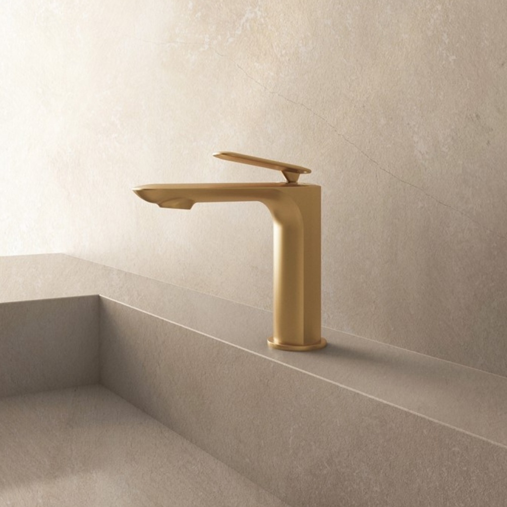 Lifestyle image of the Crosswater Huck Brushed Brass Basin Mixer Tap mounted on a basin deck